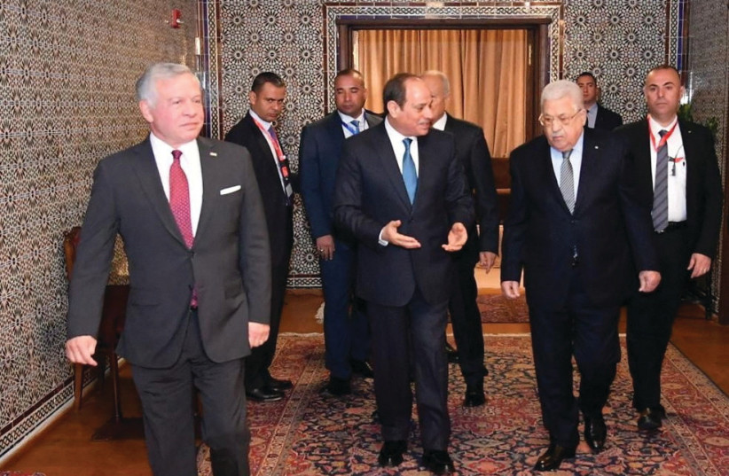  EGYPTIAN PRESIDENT Abdel Fattah al-Sisi (center) speaks with Palestinian Authority head Mahmoud Abbas as Jordan’s King Abdullah walks ahead, after a conference of Arab leaders in Cairo, last month.  (credit: Egyptian Presidency/Reuters)