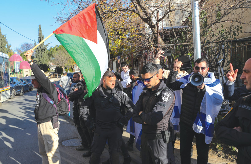  DEMONSTRATORS AND counter-demonstrators display Palestinian and Israeli flags in Jerusalem’s Sheikh Jarrah-Shimon Hatzadik neighborhood, earlier this year. (photo credit: REUTERS)