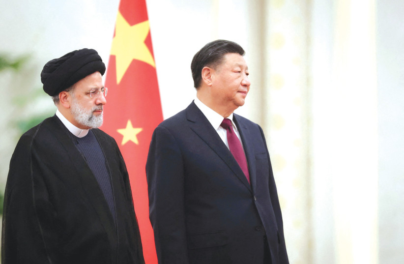  IRANIAN PRESIDENT Ebrahim Raisi stands next to Chinese President Xi Jinping during a welcoming ceremony in Beijing, last month. (photo credit: (Iran’s President Website/West Asia News Agency/Reuters))