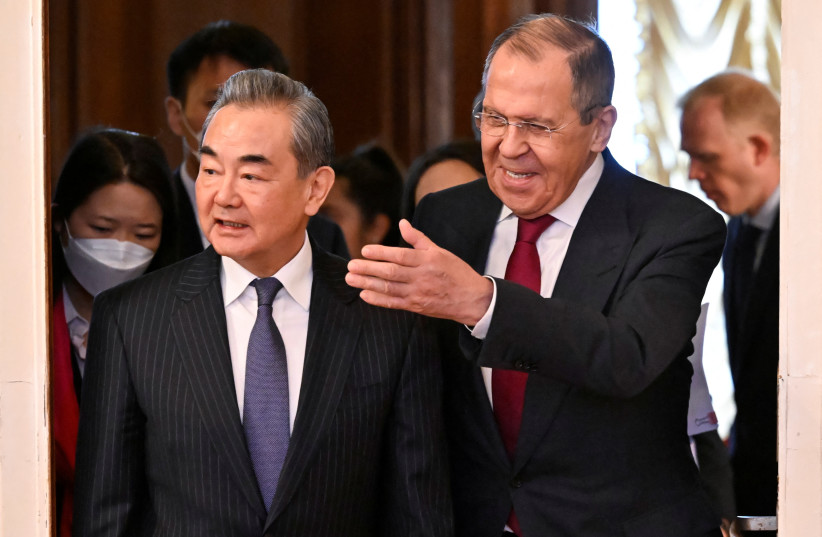  Russia's Foreign Minister Sergei Lavrov and China's Director of the Office of the Central Foreign Affairs Commission Wang Yi enter a hall during a meeting in Moscow, Russia February 22, 2023. (credit: ALEXANDER NEMENOV/POOL VIA REUTERS)