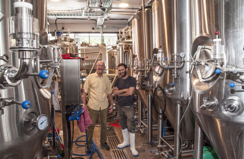  THE WRITER with Schwartz in his very compact and efficient brewery.  (credit: MIKE HORTON)