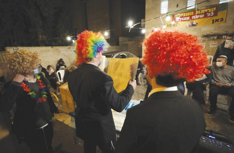  COMMUNITY READING of the Book of Esther on Purim in Jerusalem, 2021. (photo credit: AMMAR AWAD/REUTERS)