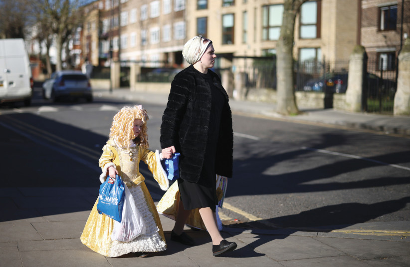  JEWISH CHILDREN dress in Purim costumes, including Queen Esther and generic female royalty, in London, 2021. (credit: HENRY NICHOLLS/REUTERS)