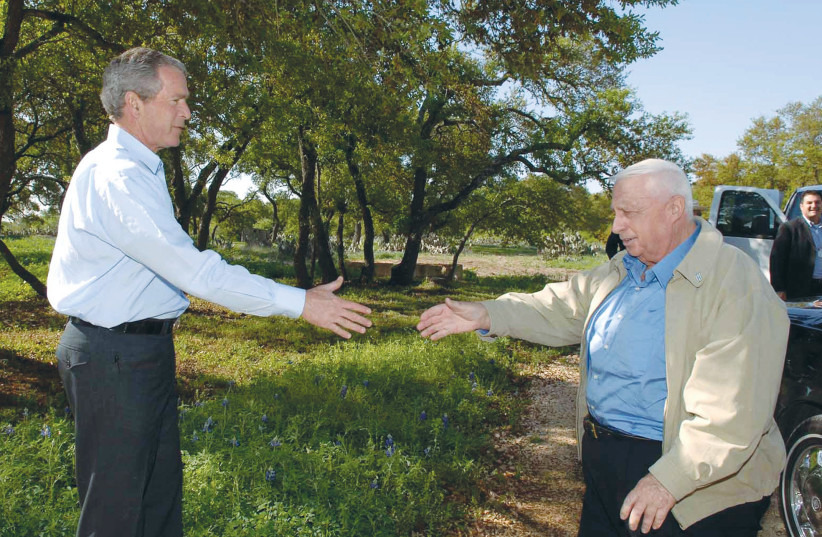  THEN-US president George W. Bush welcomes then-prime minister Ariel Sharon to the presidential ranch in Crawford, Texas, in 2005.  (photo credit: Avi Ohayon/GPO)