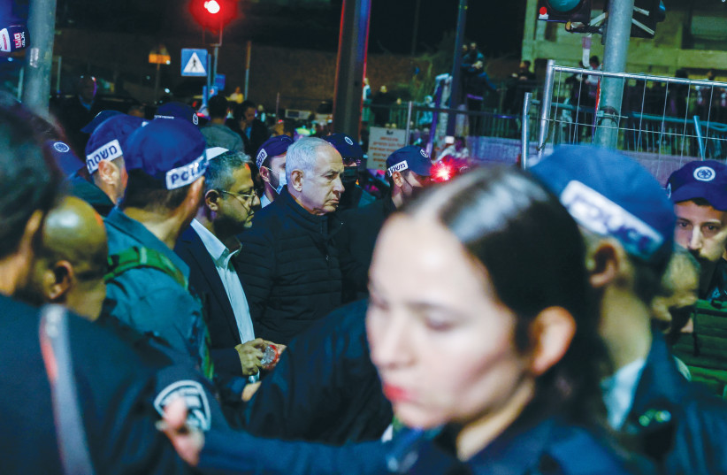  PRIME MINISTER Benjamin Netanyahu visits the scene of the synagogue attack in Jerusalem’s Neveh Ya’acov neighborhood in January, in which seven people were killed. Arab terrorism is not a response to Netanyahu or settlers, says the writer.  (photo credit: OLIVIER FITOUSSI/FLASH90)
