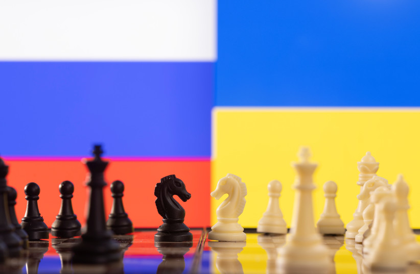 Chess pieces are seen in front of displayed Russia and Ukraine's flags in this illustration taken January 25, 2022. (credit: REUTERS/DADO RUVIC/ILLUSTRATION)