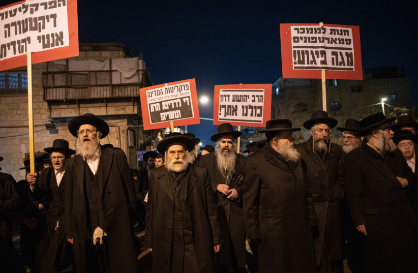  Ultra-Orthodox Jewish men protest against the arrest of an ultra orthodox man, in Jerusalem, on February 21, 2023. (photo credit: ERIK MARMOR/FLASH90)