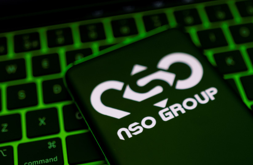 NSO Group logo is shown on a smartphone which is placed on a keyboard in this illustration taken May 4, 2022. (photo credit: REUTERS/DADO RUVIC/ILLUSTRATION)