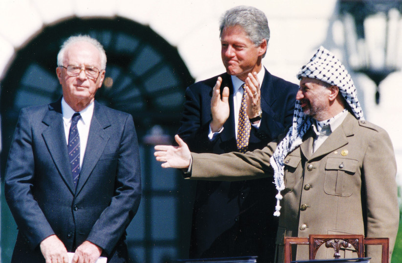  THEN-PLO chairman Yasser Arafat extends his hand to then-prime minister Yitzhak Rabin after they signed the Declaration of Principles at the White House, September 1993. The next year, Arafat reportedly delivered a speech, calling for a ‘jihad.’ (photo credit: GARY HERSHORN/REUTERS)