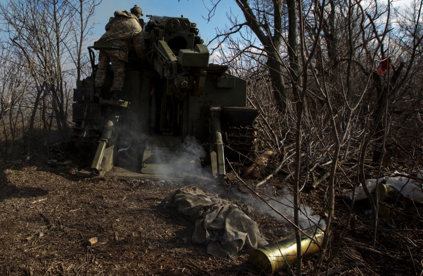  Ukrainian servicemen fire a 2S5 Giatsint-S self-propelled howitzer towards Russian troops outside the frontline town of Bakhmut, amid Russia's attack on Ukraine, in Donetsk region, Ukraine March 5, 2023. (credit: REUTERS/ANNA KUDRIAVTSEVA)