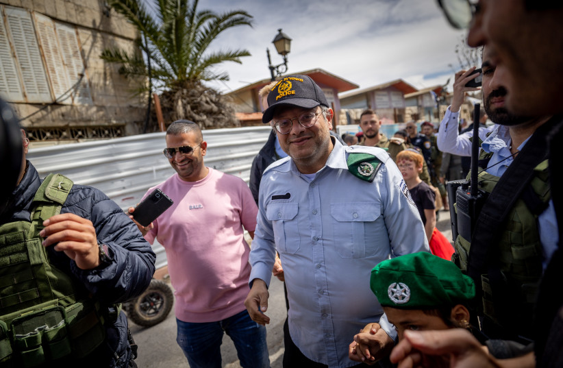  Israeli National Security Minister Itamar Ben-Gvir is seen marching in a Purim parade in Hebron in the West Bank dressed as a police officer, on March 7, 2023. (credit: YONATAN SINDEL/FLASH90)