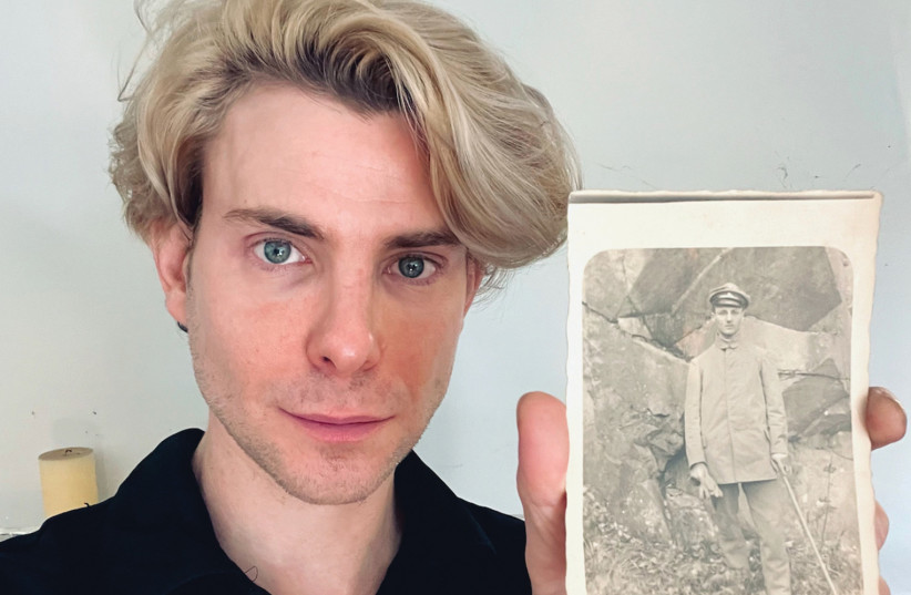  DANIEL DREIFUSS holds up a photo of his grandfather, Max Dreifuss, in 1919. Max was sent to a concentration camp after the Nazis took power.  (photo credit: DANIEL DREIFUSS/JTA)