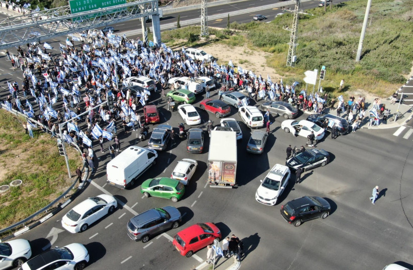  Judicial reform protestors block the road at HaKfar HaYarok youth village in Ramat Hasharon on March 9, 2023. (credit: Shai Koriansky)