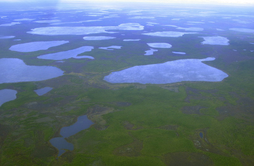 An aerial view shows thermokarst lakes outside the town of Chersky in northeast Siberia, August 28, 2007. (photo credit: REUTERS/DMITRY SOLOVYOV)