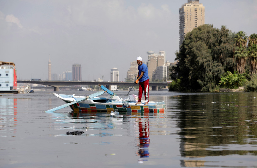 Fisherman Mohamed Nasar, 59, uses his boat to collect plastic garbage from the Nile river for the NGO called VeryNile, three generations of Nassar's family are taking part in this environment friendly initiative in Giza, Egypt, October 19, 2022. (photo credit: REUTERS/MOHAMED ABD EL GHANY)