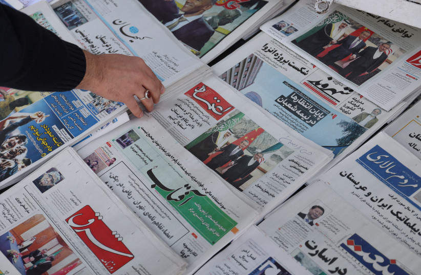  Newspapers with a cover picture of the Iranian Rear Admiral Ali Shamkhani, the secretary of the Supreme National Security Council and Saudi Minister of State and National Security Adviser Musaed bin Mohammed Al-Aiban, is seen in Tehran, Iran March 11, 2023. (credit: MAJID ASGARIPOUR/WANA/REUTERS)
