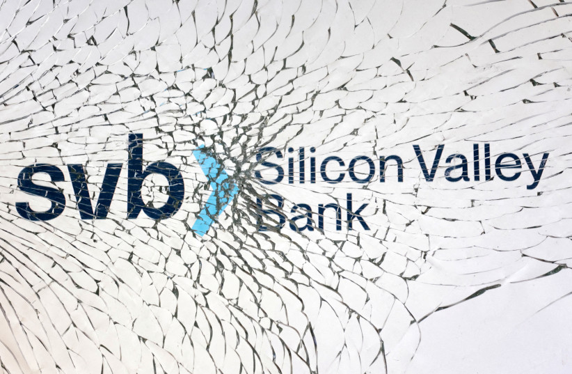  SVB (Silicon Valley Bank) logo is seen through broken glass in this illustration taken March 10, 2023.  (credit: REUTERS/DADO RUVIC/ILLUSTRATION)