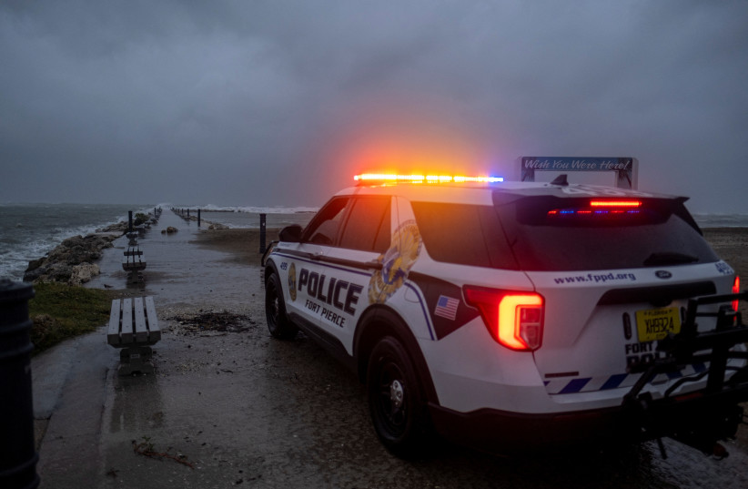  A police car blocks the entrance to the Inlet State Park before the expected arrival of Hurricane Nicole in Fort Pierce, Florida, US November 9, 2022. (photo credit: REUTERS/RICARDO ARDUENGO)