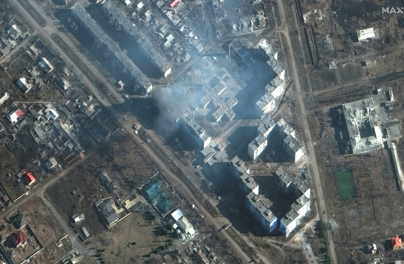 A satellite image shows a building on fire, amid Russia's attack on Ukraine, in the city of Bakhmut, Ukraine, March 6, 2023. (photo credit: MAXAR TECHNOLOGY/HANDOUT VIA REUTERS)