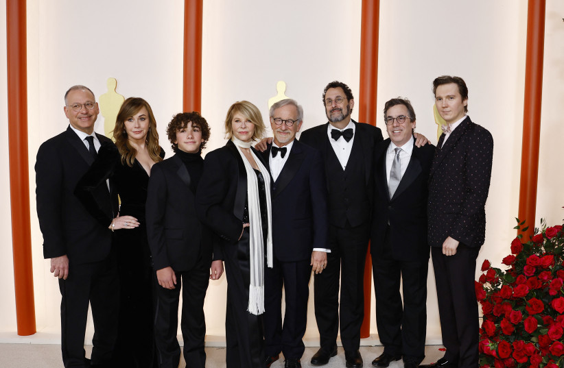  Steven Spielberg poses with the team from his movie The Fabelmans on the champagne-colored red carpet during the Oscars arrivals at the 95th Academy Awards in Hollywood, Los Angeles, California, US, March 12, 2023. (photo credit: REUTERS/ERIC GAILLARD)