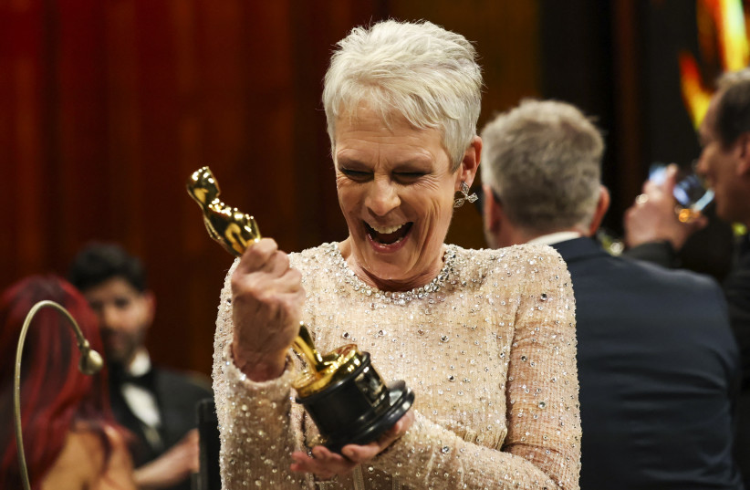  Best Supporting Actress Jamie Lee Curtis reacts while holding her Oscar at the Governors Ball following the Oscars show at the 95th Academy Awards in Hollywood, Los Angeles, California, US, March 12, 2023.  (credit: REUTERS/MARIO ANZUONI)