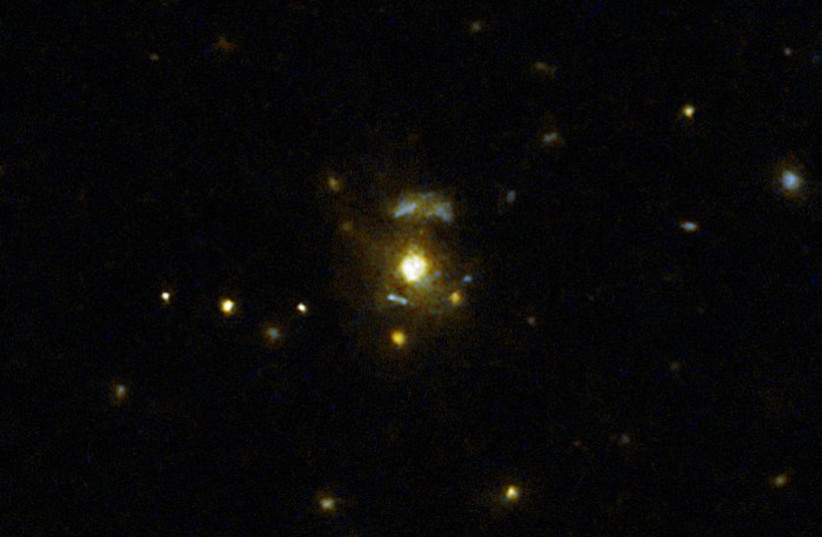  This image taken with the NASA/ESA Hubble Space Telescope shows the galaxy 3C 297, which was part of a large survey of galaxies. The galaxies in the pictures look close on a 2D image, but in reality they're in completely different parts of space. (photo credit: NASA, ESA, M. Chiaberge (STScI))