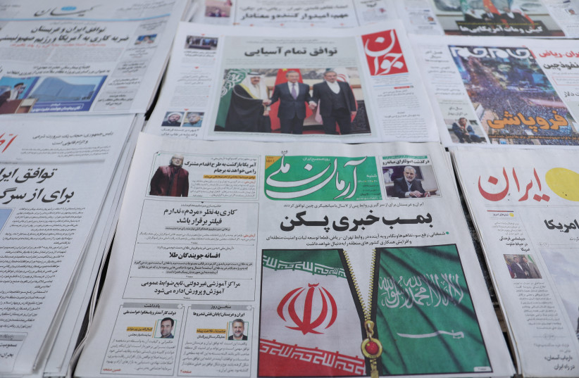  A newspaper with a cover picture of the flag of Iran and Saudi Arabia, is seen in Tehran, Iran March 11, 2023 (credit: MAJID ASGARIPOUR/WANA (WEST ASIA NEWS AGENCY) VIA REUTERS)