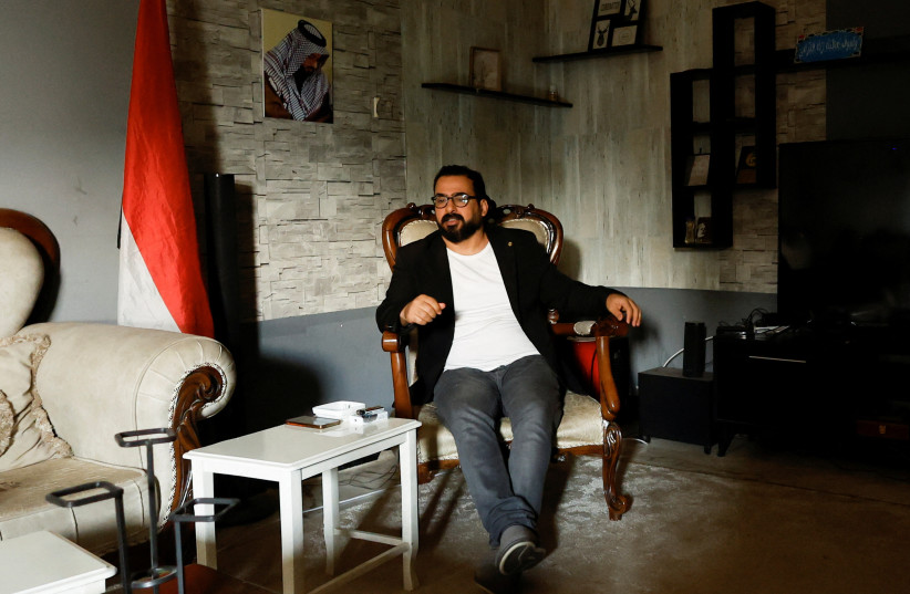  Iraqi journalist Muntadhar al-Zaidi, who gained fame for hurling his shoes at president George W. Bush during a joint statement with Iraqi prime minister Nouri al-Maliki in December 14, 2008, sits at his home in Baghdad, Iraq, March 8, 2023. (photo credit: ALAA AL-MARJANI/REUTERS)