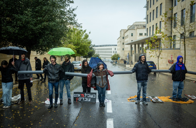  Israelis block a road near the government complex during a protest against the government's planned judicial overhaul, in Jerusalem, March 14, 2023. (credit: YONATAN SINDEL/FLASH 90)