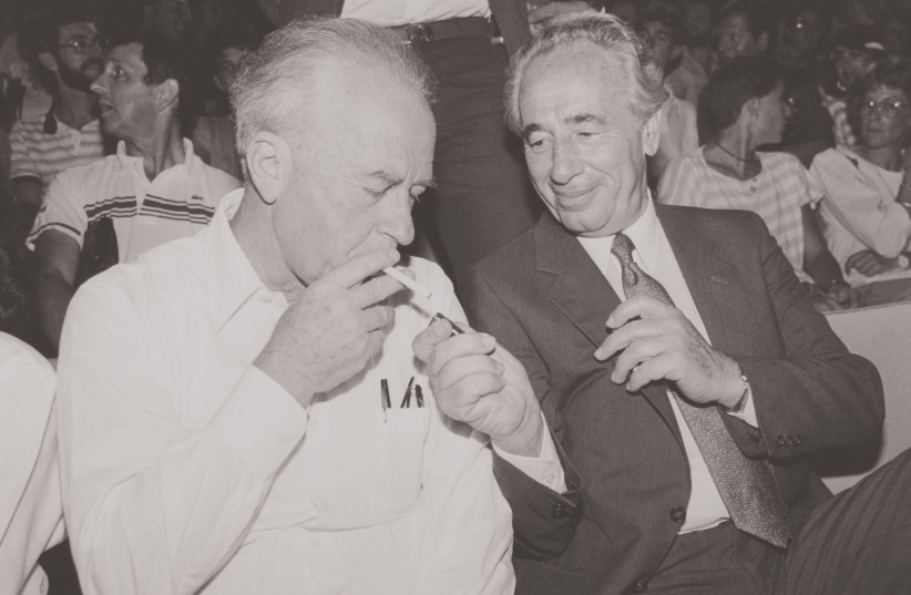  1986: SHIMON PERES shares a light moment with Yitzhak Rabin. The previous year, Peres – as prime minister – implemented an economic stabilization plan.  (photo credit: MOSHE SHAI/FLASH90)