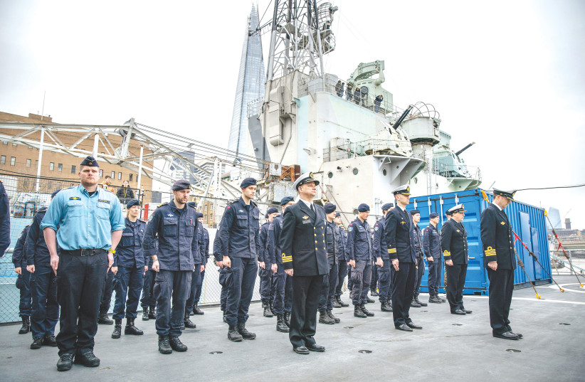  SOLDIERS MARK a moment of silence on board HNoMS Nordkapp, part of a multinational task group of five NATO warships docked in London, on the anniversary of Russia’s invasion of Ukraine, on February 24 (photo credit: Anna Gordon/REUTERS)