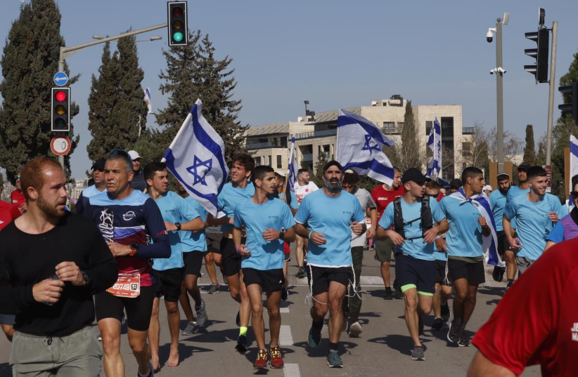  Participants run during the Jerusalem Winner Marathon, on March 17, 2023. (credit: MARC ISRAEL SELLEM/THE JERUSALEM POST)