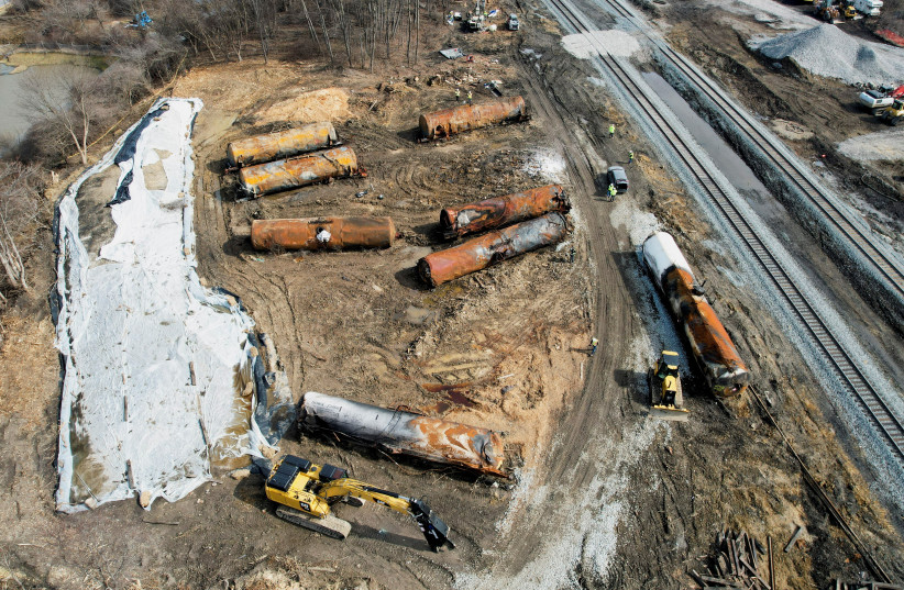  People clean up the site following the derailment of a train carrying hazardous waste in East Palestine, Ohio (credit: REUTERS)