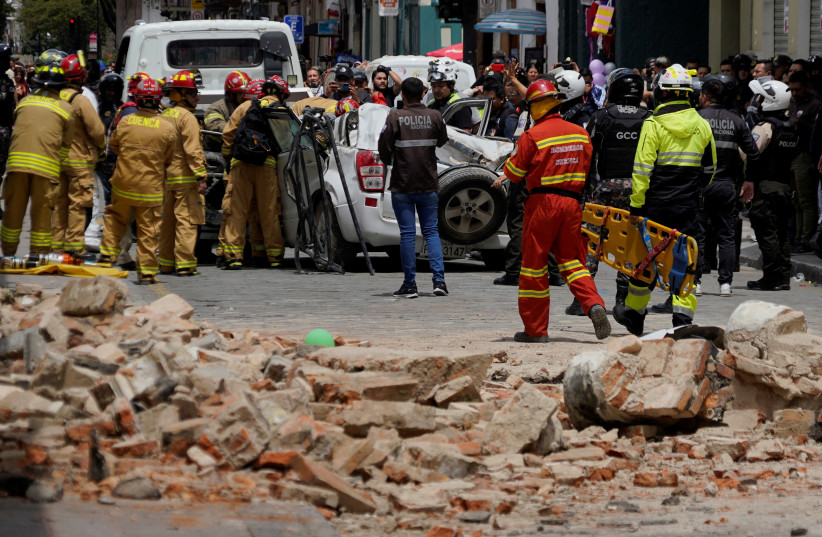 A damaged car and rubble from a house affected by the earthquake are pictured in Cuenca, Ecuador, March 18, 2023. (photo credit: REUTERS/RAFA IDROVO ESPINOZA)