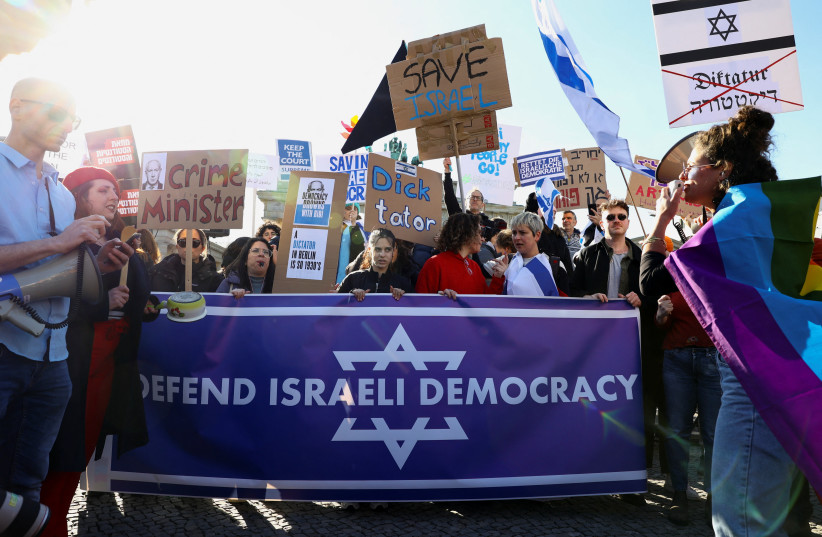  Protesters demonstrate against the planned justice reform of Israeli Prime Minister Benjamin Netanyahu, during Netanyahu's visit to Germany, in Berlin, Germany, March 16, 2023. (credit: REUTERS/CHRISTIAN MANG)
