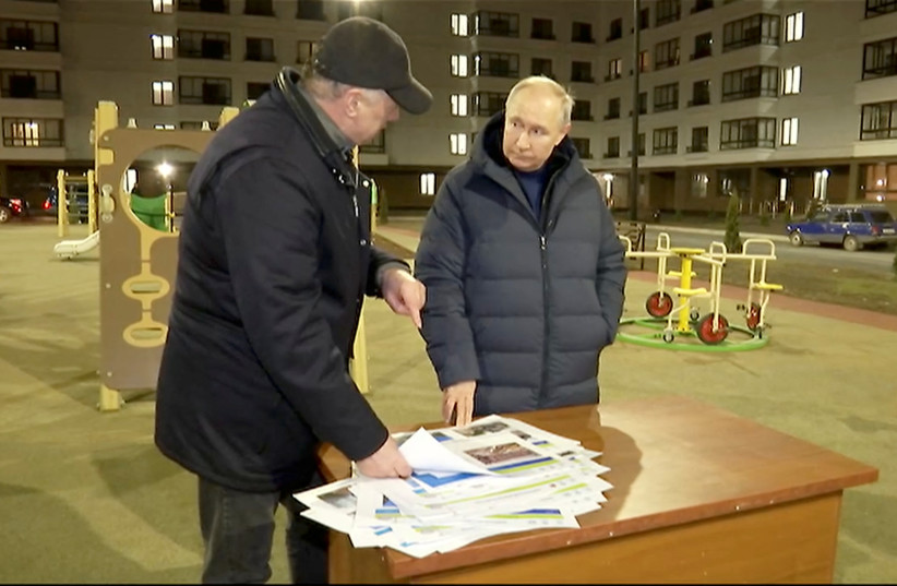 Russian President Vladimir Putin listens to Deputy Prime Minister Marat Khusnullin, who heads construction and regional development, as he visits Mariupol, Russian-controlled Ukraine, in this still image taken from handout video released on March 19, 2023. (credit: KREMLIN.RU/HANDOUT VIA REUTERS)