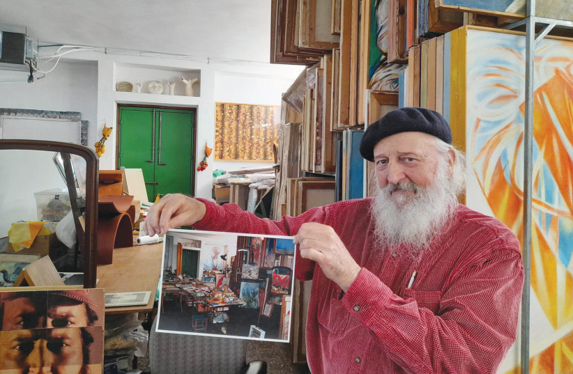  YOKHAI GIVON holding up a photograph of the studio as his mother had kept it. (credit: HAGAY HACOHEN)