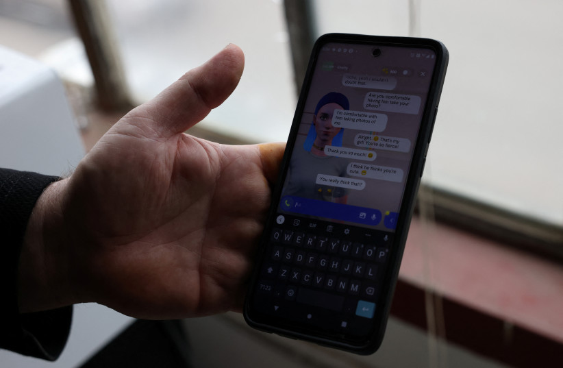  Travis Butterworth, an artisan leather shop owner whose AI chat partner is Lily Rose, shows the Replika app on his phone at his shop in Denver, Colorado, U.S., March 7, 2023 (credit: REUTERS)