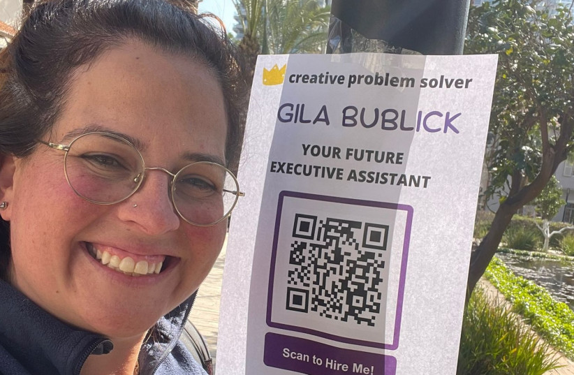  Gila Bublick, an ola job seeker, standing beside a unique QR code sign posted around Tel Aviv's hi-tech scene. (credit: COURTESY/GILA BUBLICK)