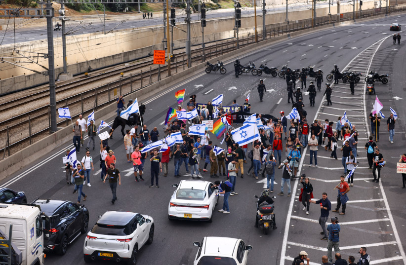  Demonstrators attend the ''Day of Paralysis'' protest, as Prime Minister Benjamin Netanyahu's coalition government presses on with its judicial overhaul, in Tel Aviv, Israel March 23, 2023 (credit: REUTERS/Ronen Zvulun)