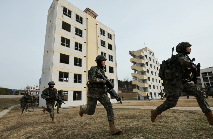  South Korean soldiers take part in a joint military drill which is a part of the Freedom Shield joint military exercise between South Korea and US, at a military training field near the demilitarized zone separating the two Koreas in Paju, South Korea, March 16, 2023.  (credit: YONHAP VIA REUTERS)
