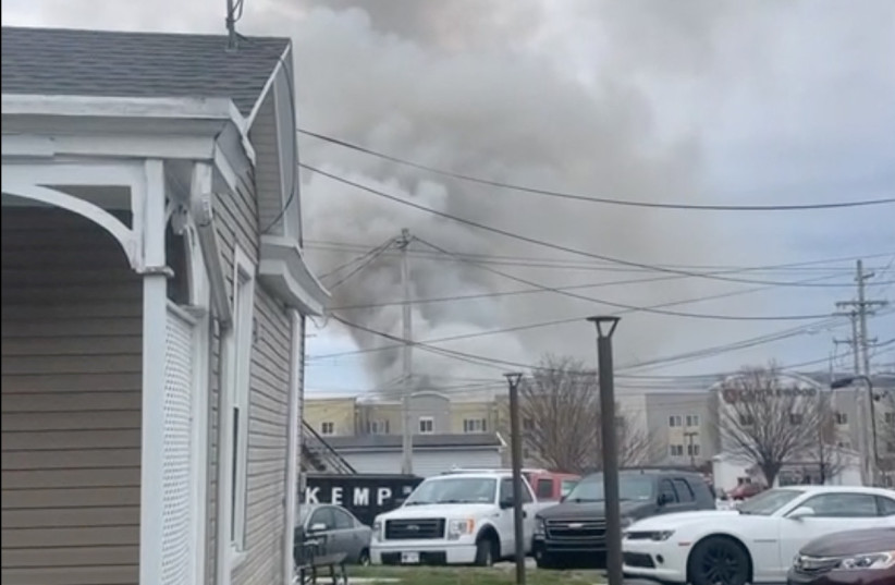 A general view shows smoke coming out from a chocolate factory after fire broke out, in West Reading, Pennsylvania, U.S., March 24, 2023 in this screen grab obtained from a social media video. (credit: Twitter @Based_In410/via REUTERS)