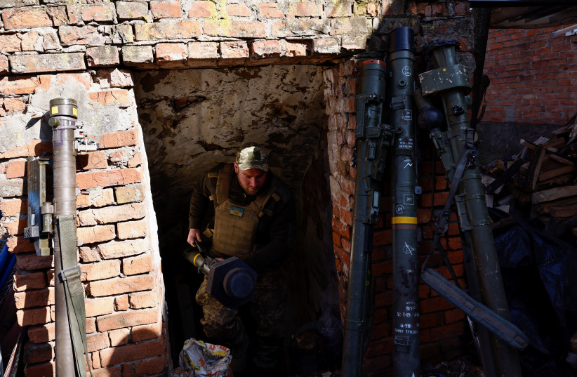 Anti-aircraft unit serviceman of the 10th Mountain Assault Brigade, call sign ''Chub'', 34, emerges from a storage basement with a portable anti-aircraft missile system amid Russia's attack on Ukraine, near Soledar north of Bakhmut, Ukraine, March 23, 2023. (credit: REUTERS/VIOLETA SANTOS MOURA)