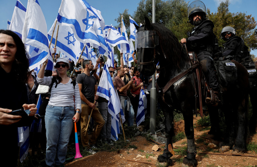 Mounted police officers confront judicial reform demonstrators in Jerusalem, March 27, 2023 (credit: AMMAR AWAD/REUTERS)