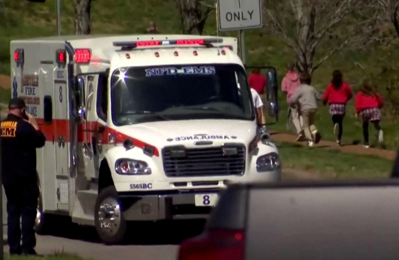  Children run past an ambulance near the Covenant School after a shooting in Nashville, Tennessee, US March 27, 2023 (credit: WKRN/NEWSNATION VIA REUTERS)