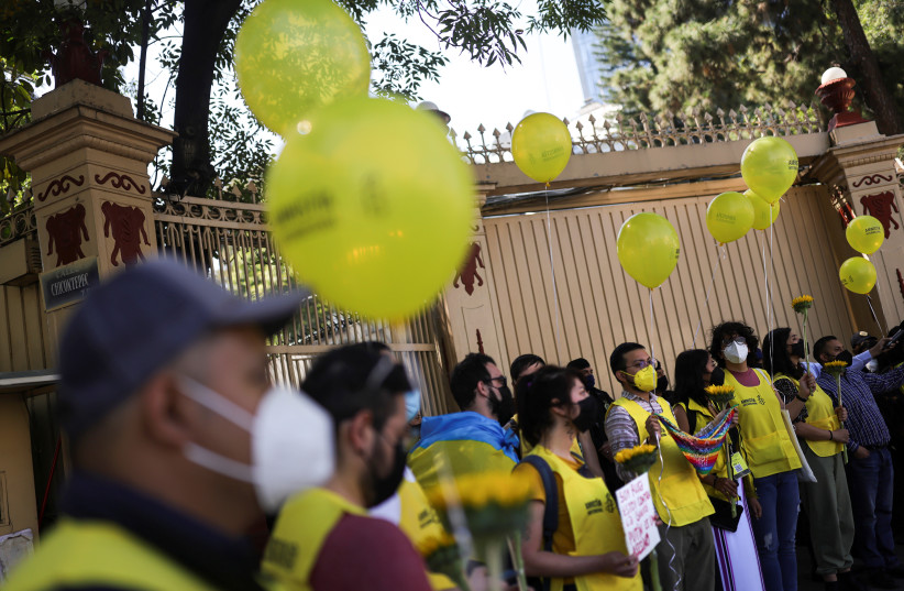 Activists from Amnesty International protest outside the Russian Embassy as part of a Global Day of Action for Ukraine, following Russia's invasion in Mexico City, Mexico, March 24, 2022. (credit: REUTERS/EDGARD GARRIDO)