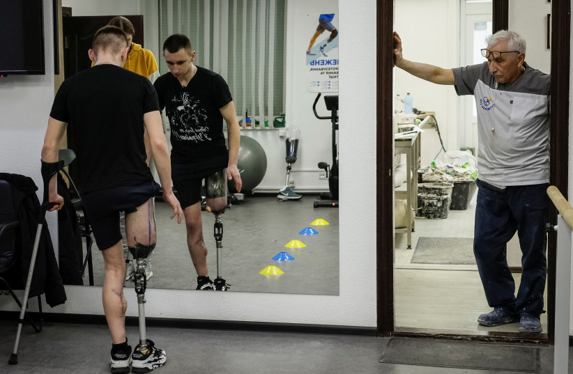  Dmytro Zilko, a soldier and a patient of the clinic exercises on a new prosthesis with rehabilitation specialist Maria in a prosthetics clinic in Kyiv, Ukraine, March 9, 2023. (credit: REUTERS/ALINA YARYSH)