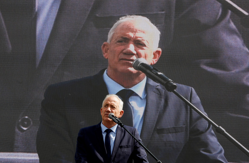  Israel's opposition leader Benny Gantz addresses protesters at a demonstration after Israeli Prime Minister Benjamin Netanyahu dismissed the defense minister as his nationalist coalition government presses on with its judicial overhaul, in Jerusalem, March 27, 2023.  (credit: AMMAR AWAD/REUTERS)