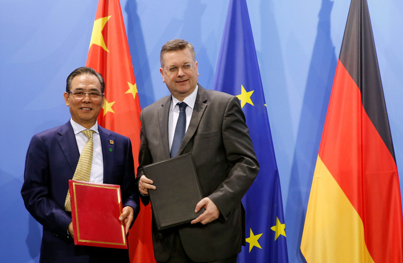  Cai Zhenhua, deputy director of China's General Administration of Sport and president of the Chinese Football Association (L) and German Football Association (DFB) President Reinhard Grindel pose following a signing ceremony in Berlin, Germany, November 25, 2016.  (credit: FABRIZIO BENSCH / REUTERS)
