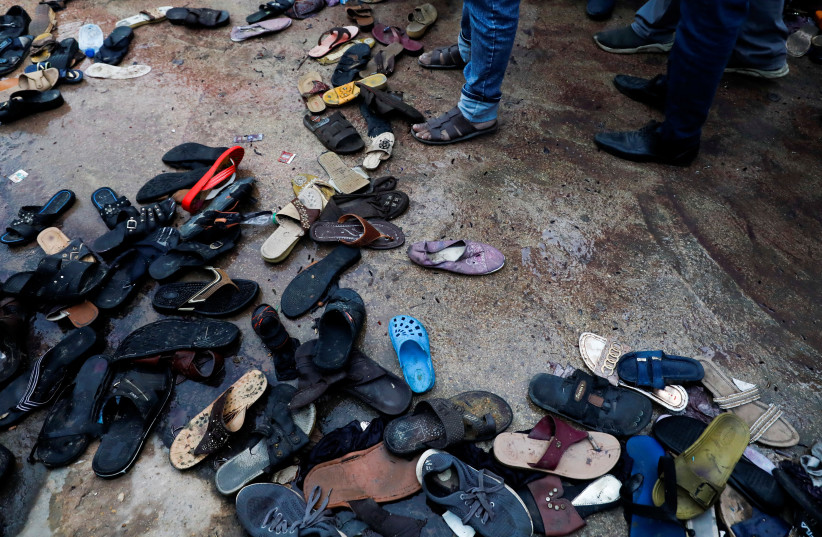  A view of a site with a pile of footwear after a stampede occurred during handout distribution, in Karachi, Pakistan March 31, 2023. (credit: REUTERS/AKHTAR SOOMRO)